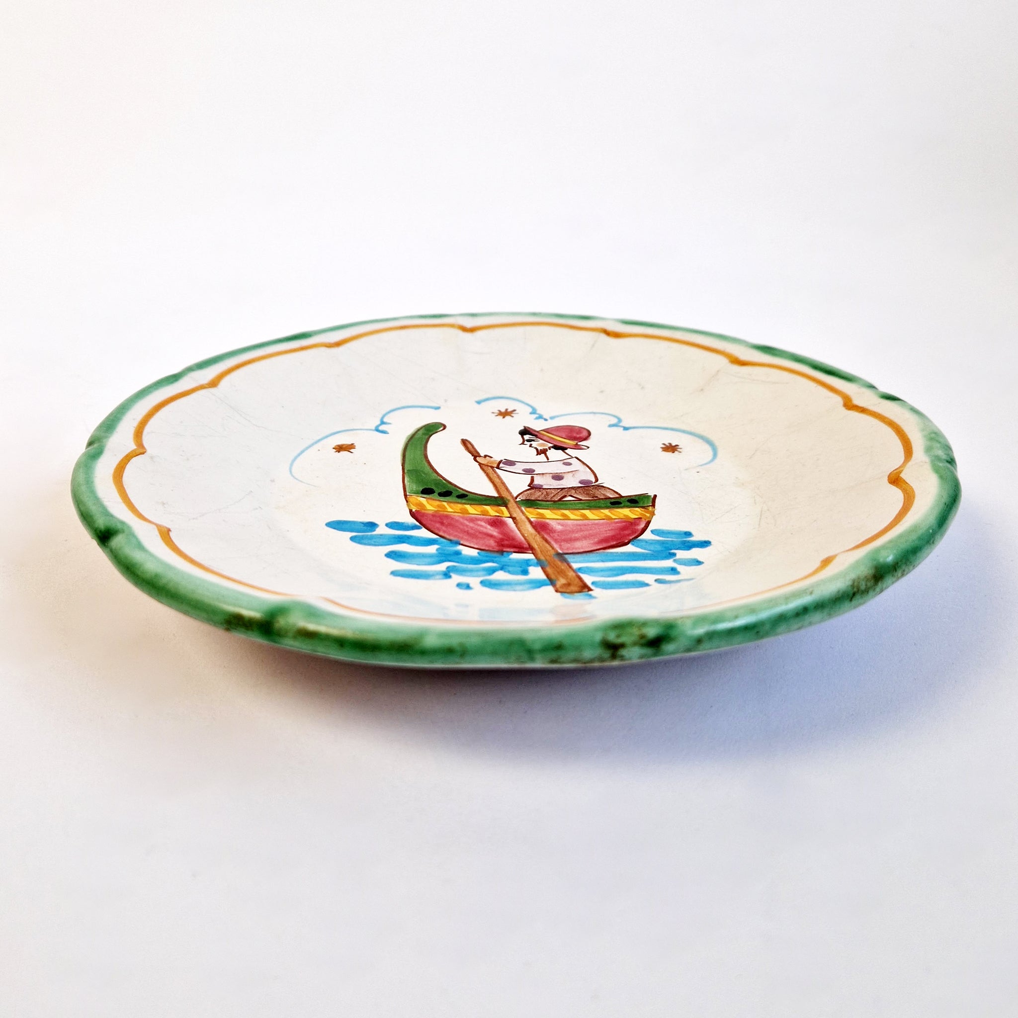 Mid-century hand-painted wall plate with fisherman