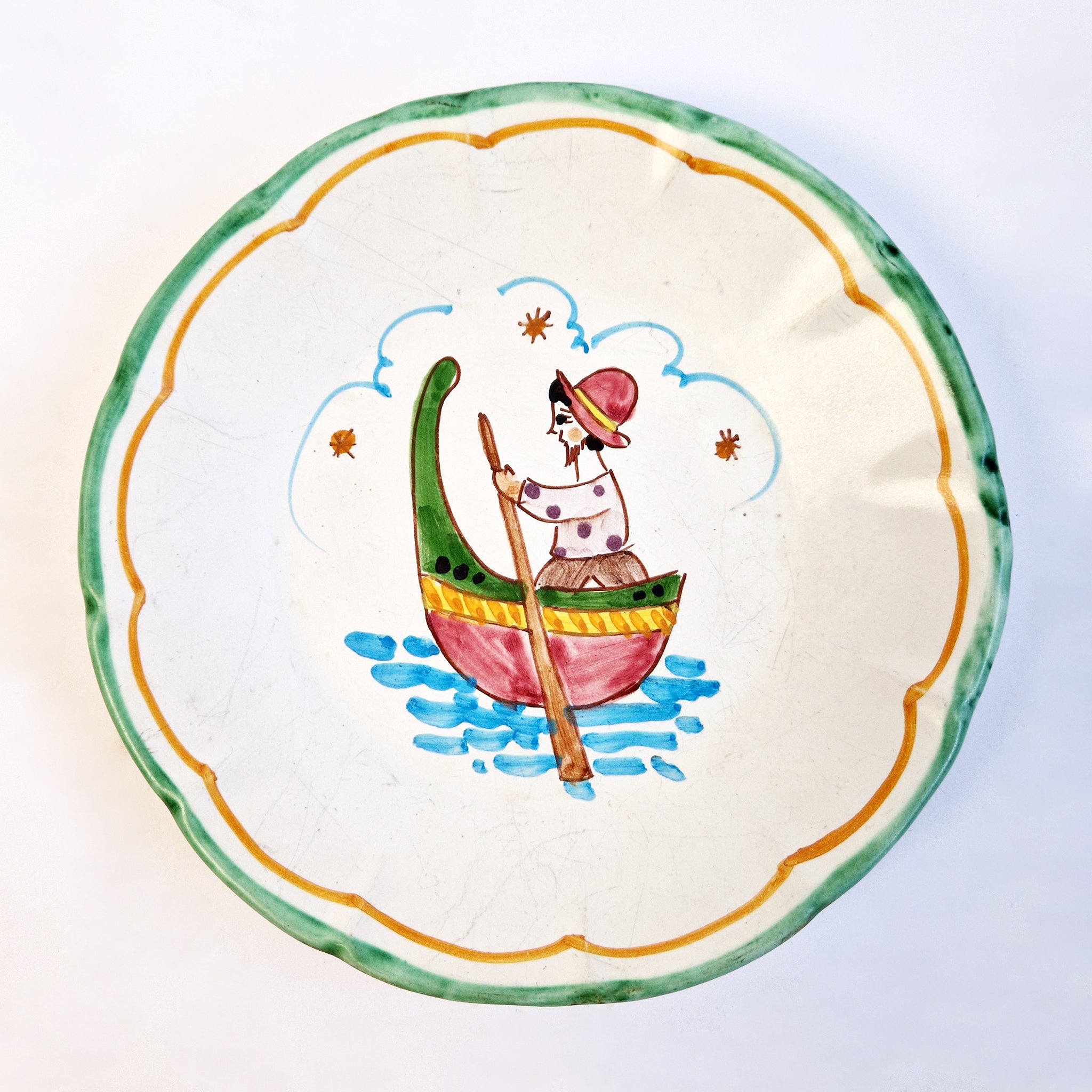 Mid-century hand-painted wall plate with fisherman