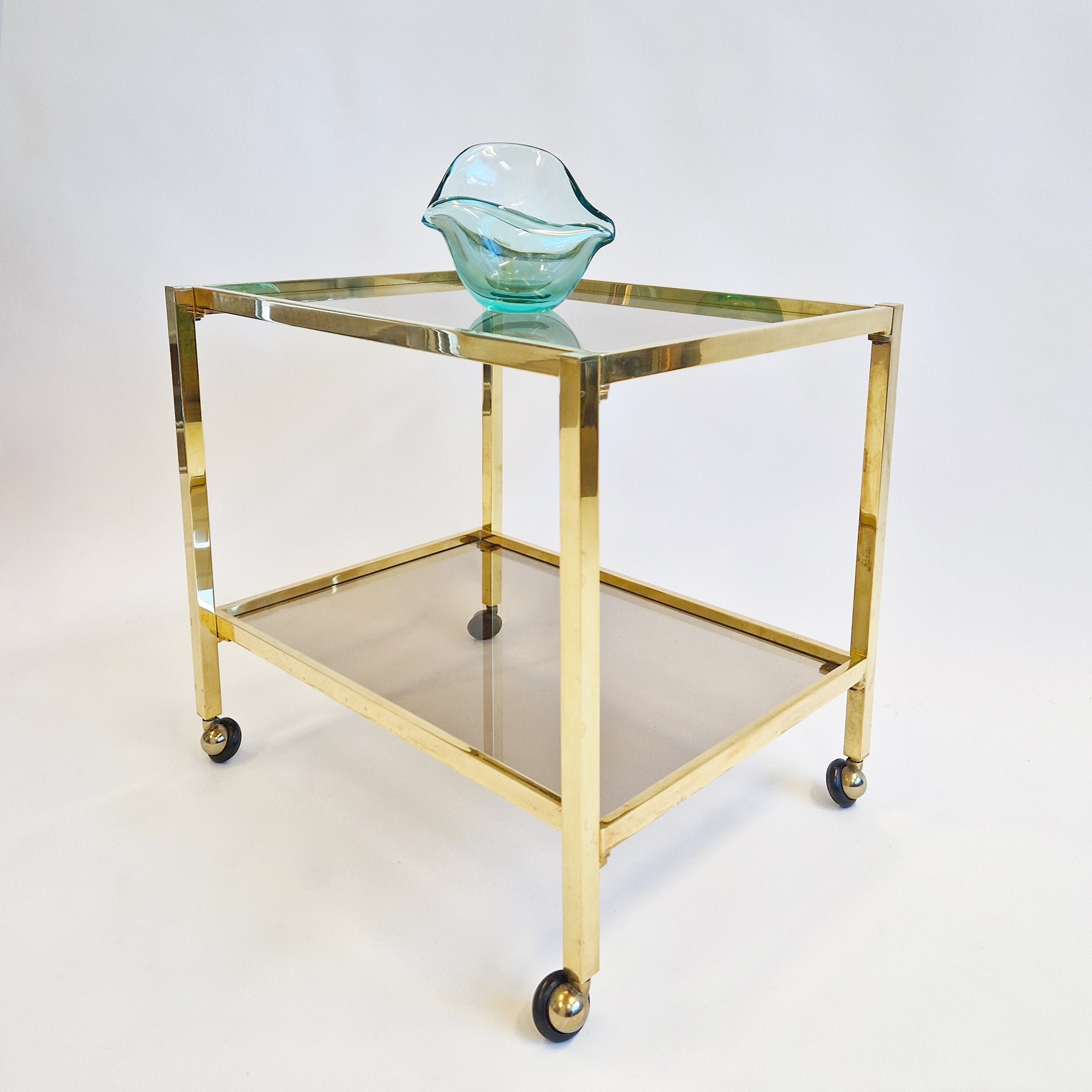 Vintage Italian brass side table on wheels