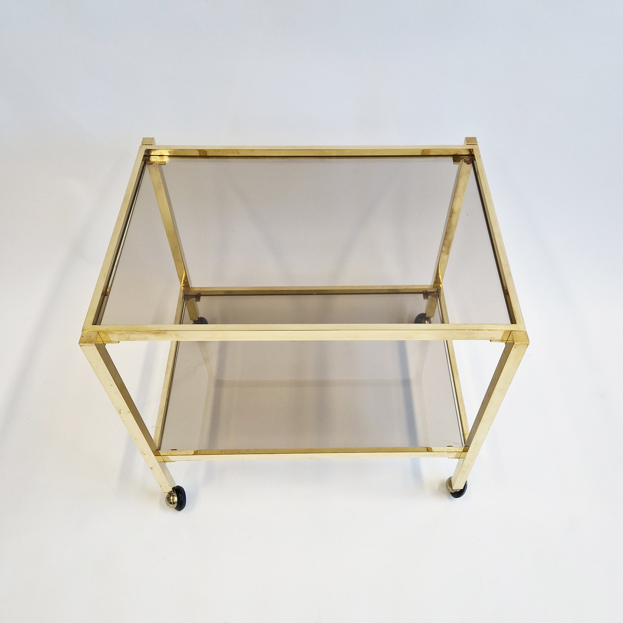 Vintage Italian brass side table on wheels