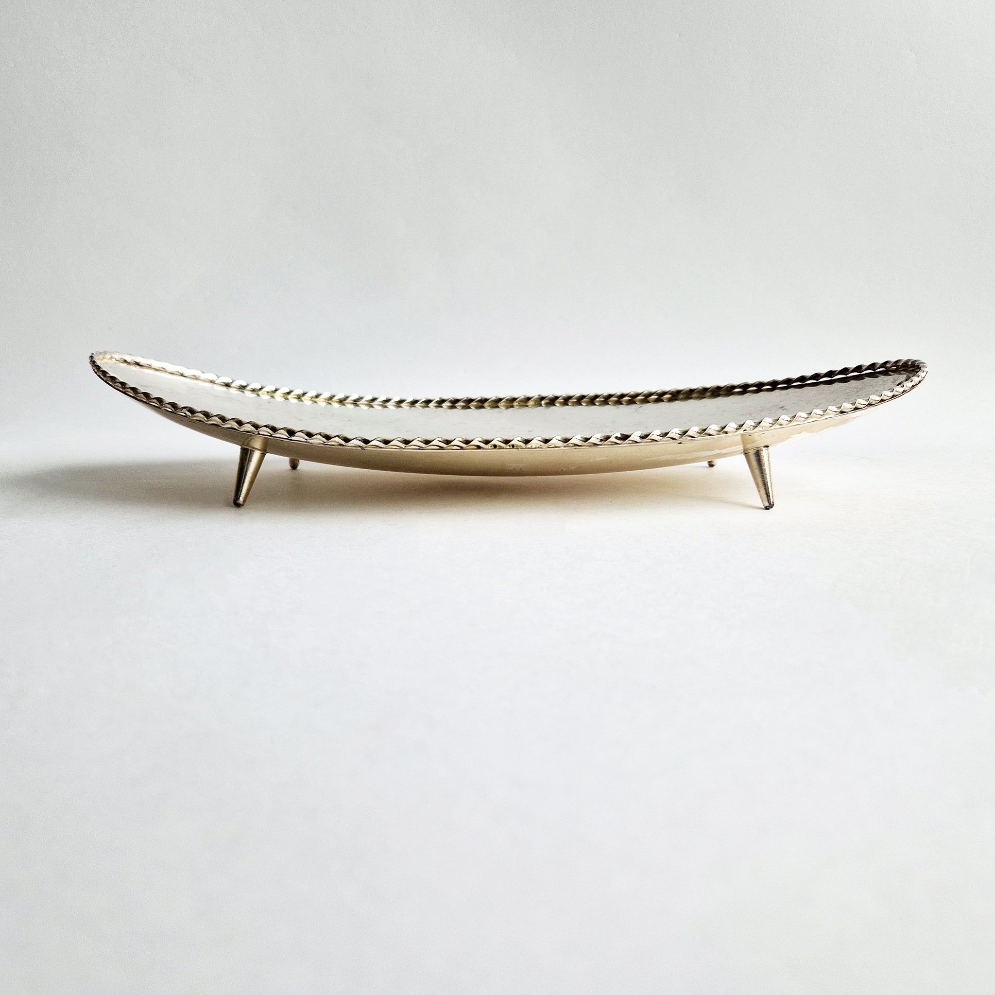 Vintage dish with scalloped edge and stiletto legs