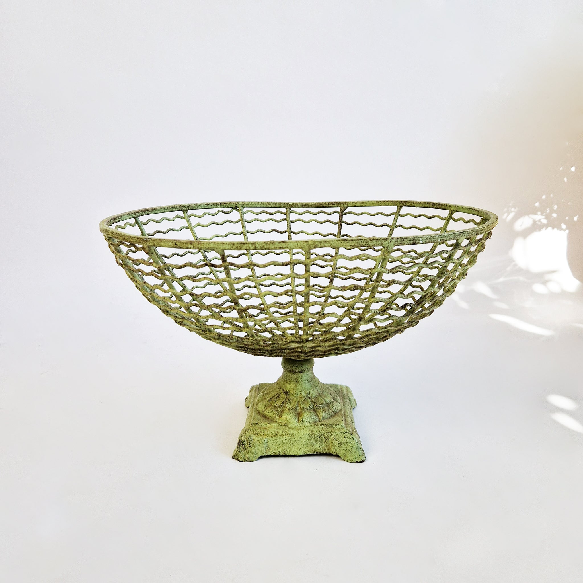 Vintage iron fruit basket on pedestal