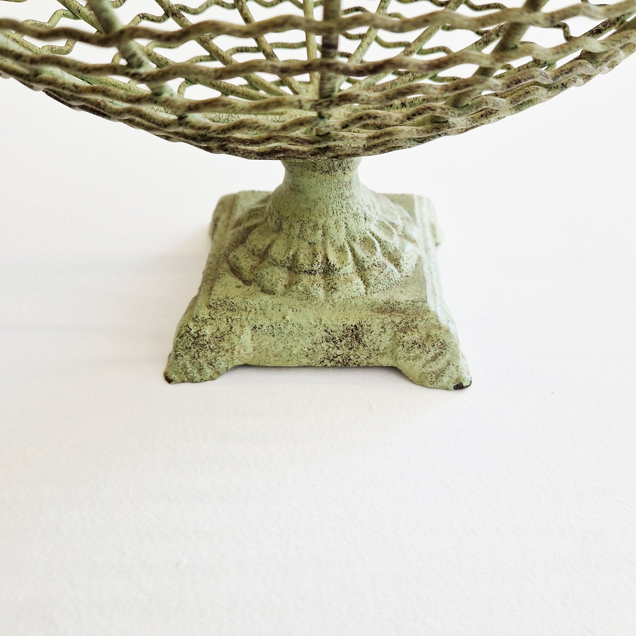 Vintage iron fruit basket on pedestal